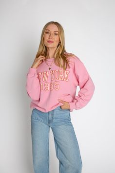 This Big City Sweatshirt is for city slickers and aspirants alike! Crafted from a light pink fabric, it features "New York 1995" in cream with a red outline - the perfect way to rep the city that never sleeps. With its oversized baggy fit, loose long sleeves, dropped shoulders, and crew neckline, it'll have you feeling comfortable and city-ready. Hit the streets in style! Materials: Shell: 100% Cotton Fit: This oversized sweatshirt fits true to size Length: The length of this sweatshirt falls on Oversized Pink Crewneck Sweatshirt, Urban Style Pink Long Sleeve Sweatshirt, Oversized Pink Comfortable Sweatshirt, Pink New York Sweatshirt, Pink Crew Neck Soft-washed Sweatshirt, City Slickers, Adhesive Bra, City That Never Sleeps, Pink Sweatshirt