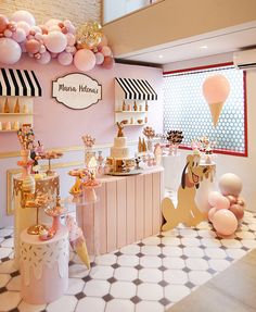 an ice cream parlor decorated in pink and gold with unicorn themed decorations on the walls