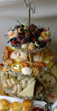 three tiered trays filled with different types of food