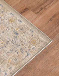 an area rug is laying on the floor in front of a wooden flooring surface