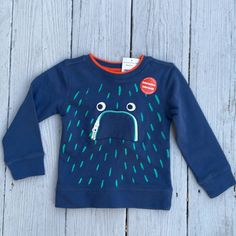 Brand New With Tags Fun Blue Top For Fall, Fun Blue Tops For Fall, Fun Blue Cotton Sweatshirt, Blue Cotton Fun Style Sweatshirt, Fun Blue Long Sleeve T-shirt, Navy Cotton Playwear Top, Playful Long Sleeve Blue T-shirt, Fun Blue Tops For Playtime, Blue Cartoon Print Tops For Playtime