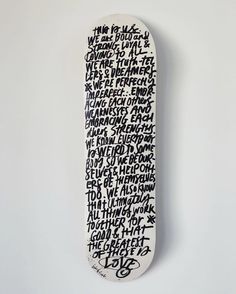 a white skateboard with black writing on it