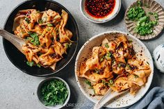 several plates of food on a table with chopsticks