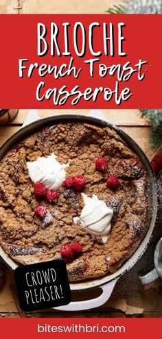 a close up of a casserole in a pan with whipped cream and raspberries