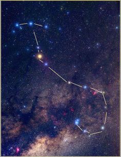 the zodiac sign is in the middle of the night sky, with stars all around it