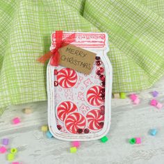 a jar filled with candy canes sitting on top of a table