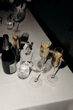 wine glasses and bottles are sitting on a table