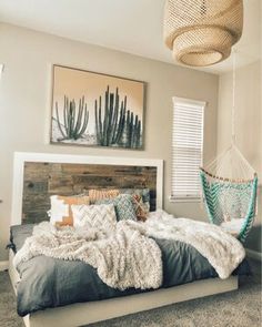 a bedroom with a large bed and pictures on the wall above it, along with a hanging hammock chair