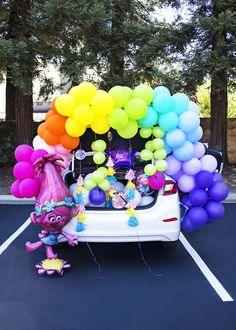 there is a car with balloons in the trunk