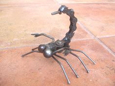 Scorpion garden art sculpture. Made from bike chain, ball bearing eyes. Proudly handcrafted in Kentucky by artist Richard Kolb. These pieces naturally rust with age. To prevent rust, treat them with a clear acrylic enamel spray, like Krylon® or Rustoleum®. Size 3.5" High About Artist Richard Kolb :Yard Birds - Garden SculpturesMy father and I created the first Yardbird over 20 years ago in Jamestown, Kentucky. He spent most of his career making things out of metal, including farm gates and large Outdoor Metal Art, Metal Sculptures Garden, Silverware Art, Metal Tree Wall Art, Metal Yard Art, Metal Garden Art, Junk Art, Steel Art, Bike Chain