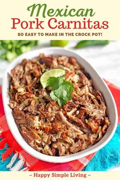 mexican pork carnitas in a white bowl with a lime garnish on top