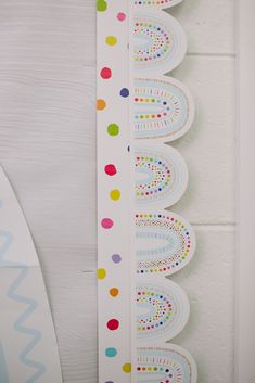 three colorful polka dot stickers on a white wall