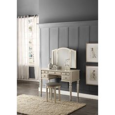 a bedroom with gray walls and furniture in the room, including a dressing table and stool