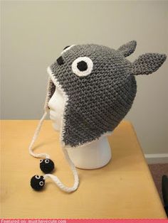 a crocheted hat with eyeballs on it