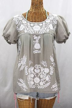 "* Ornate hand embroidery and traditional puff sleeves, available here in GREY with WHITE embroidery. * Light, gauzy and semi-sheer 100% cotton throughout; wear it billowy and flowing in the traditional bohemian style. * Dyed, distressed and embroidered entirely by hand for an authentic, retro-vintage and hippie casual vibe. * Our ornate butterfly floral embroidery patterns are a faithful tribute to the original Mexican style hippie blouses of the 1970's. * Caringly embroidered by hand, each top Affordable Peasant Blouse With Floral Embroidery, Affordable Tunic Top With Floral Embroidery, Cheap Floral Embroidered Tunic Top, Cheap Bohemian Embroidered Blouse, Cheap Casual Embroidered Peasant Top, Cheap Embroidered Peasant Top For Vacation, Mexican Shirts Woman, Mexican Peasant Blouse, Look Hippie Chic