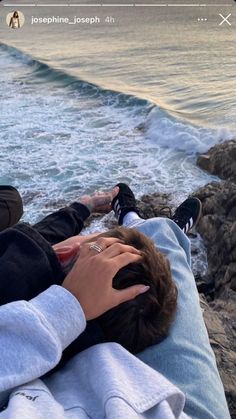 a person laying on top of a beach next to the ocean