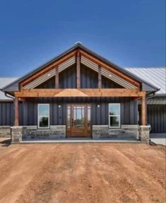 a large house sitting on top of a dirt field