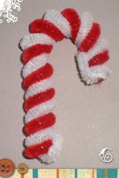 a red and white candy cane on top of a table