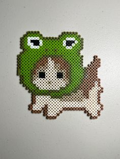 a cross stitch pattern of a green bear