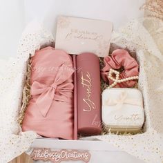 a pink gift box filled with personalized items