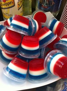 red, white and blue jellopops sitting on top of each other in plastic containers