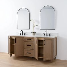 two mirrors are above the double sinks in this bathroom