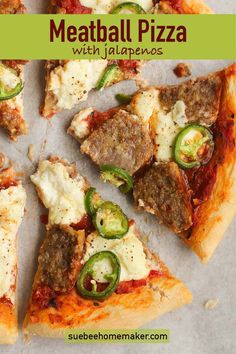 meatball pizza with jalapenos on a sheet of parchment paper and topped with cheese