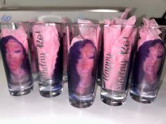 five shot glasses with pink tissue wrapped in the image of a woman's face