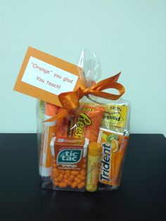 an orange gift bag filled with candy and candies