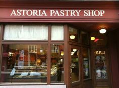 the store front of a pastry shop with large windows