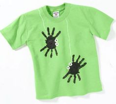 a green t - shirt with black handprints on the front and hands across the chest