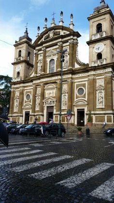 an old church with cars parked in front