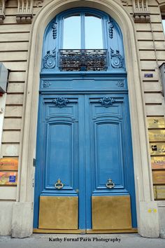 a large blue door with gold trim on it