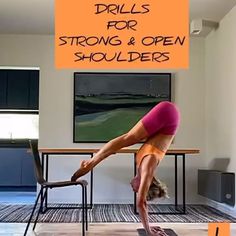 a woman doing a handstand in front of a table with an orange sign that says drills for strong & open shoulders