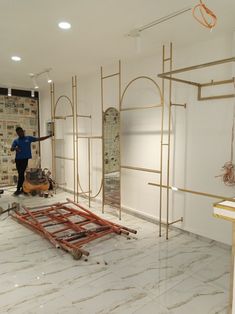 a man is standing in the middle of a room that's being constructed with gold and marble