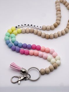 These gorgeous lanyards are made with 10mm wooden beads and paired with clay, acrylic, or metal spacers! We use high quality bead wire which allows you to move throughout your day without worrying about the strength of your lanyard. Each lanyard is 34 inches long, includes a keyring and lobster claw, and can be personalized to include your name or any other saying. You can choose from four different bead colors for personalization and add on a tassel too! ⭐️if you prefer your lanyard to be short Wooden Bead Lanyard, Diy Teacher Lanyard Beads, Teacher Lanyard Ideas, Diy Lanyard Beaded, Beaded Lanyards Diy, Diy Teacher Lanyard, Personalized Lanyard, Teacher Lanyard Beaded, Teacher Lanyards