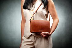 The small Old Town Leather handbag for women will be a universal purchase for daily walks and parties. You can carry cosmetics, wallet, hairbrush, documents and wallet in it. Modern and sleek design complements the varied personalization of Old Town Leather. The bag can have your name, initials, gold, silver or hot stamping. We bring to your attention a wide range of genuine leather: cognac, caramel, chocolate, black, dark blue, blue, red, olive, burgundy, green, cappuccino, yellow. With Old Tow Leather Clutch For Gift, Versatile Shoulder Bag As Gift, Leather Handheld Clutch For Travel, Cognac Leather Bag, Tote Leather Bag, Handmade Leather Bag, Woman Bag, Chocolate Leather, Genuine Leather Totes