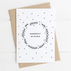 a greeting card with the words warmest wishes in a circle surrounded by leaves and dots