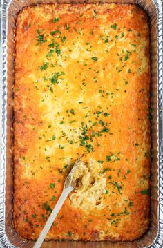 a square casserole dish with cheese and parsley on top, ready to be eaten