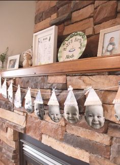 a fireplace mantle decorated with baby's first birthday hats