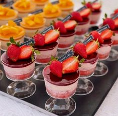 small desserts with strawberries are arranged on a tray