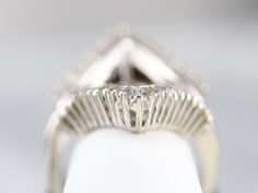 This bold statement piece is crafted of bright, white gold and glittering baguette-cut diamonds, this vintage ring dates to the 1990s and has a lovely, refined profile on the finger. Open in the center, this can be set with a solitaire gemstone ring of any color to create a luxurious frame for a simple ring. Metal: 14K White Gold Gem: 42 Diamonds totaling 1.26 Carats, I in Color, SI2 in Clarity Width of Band: 25.3 mm Height off Finger: 6.1 mm Gap Measurements: 8.0 mm Ring Size: 7.50 Solitaire Enhancer, Enhancer Ring, Statement Rings Diamond, Diamond Cocktail Ring, Simple Ring, Cameo Ring, Diamond Cocktail Rings, Gold Diamond Ring, White Gold Diamond Rings