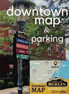 a street light sitting on the side of a road next to a sign that says downtown map and parking