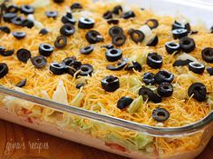 a casserole dish with black olives and cheese