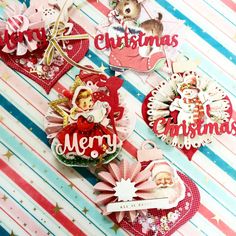 some christmas ornaments are hanging on a striped wall with red and white stripes in the background