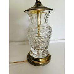 a glass table lamp with a brass base