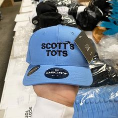 "Scotts Tots - Premium Snapback Hat Baby Blue The Scotts Tots Premium Snapback cap is sure to become your wardrobe staple with the classic snapback cap construct with premium wool-blend fabric. Match it with any attire for an elevated street style. * Classic snapback cap with premium wool blend fabric * Hard buckram. Structured * Matching plastic snapback closure * Classic green undervisor, 8-row stitching on visor Contents: 80% Acrylic / 20% Wool PROFILE: High VISOR: Flat PANELS: 6 CROWN: 3 ¾\" Elevated Street Style, The Scotts, Dunder Mifflin, Office Office, Funny Hats, Michael Scott, Hat Baby, Snapback Cap, Style Classic