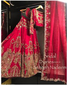 a red bridal dress hanging on a rack