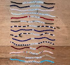 several bracelets are laid out on a wooden surface, including one with beads and the other with beading