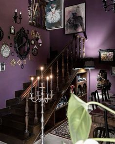 a staircase with candles and pictures on the wall